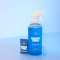 Blue Bathroom Cleaner GreenTab in forever bottle in front of blue backdrop